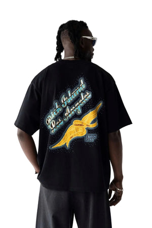 Person wearing a black t-shirt with a colorful design on the back against a white background