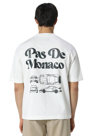 Person wearing a white t-shirt with 'Pas De Monaco' design on the back
