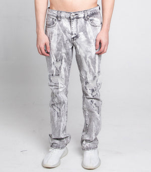 Person wearing acid-wash jeans on a plain background