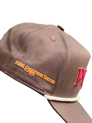 Brown cap with visible branding on a gray surface