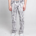 Person wearing acid-wash jeans on a plain background