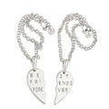 Two silver friendship necklaces with broken heart pendants that read 'BE FRI FORE' and 'ST ENDS VER', displayed on a light cream background with text indicating $575 each.