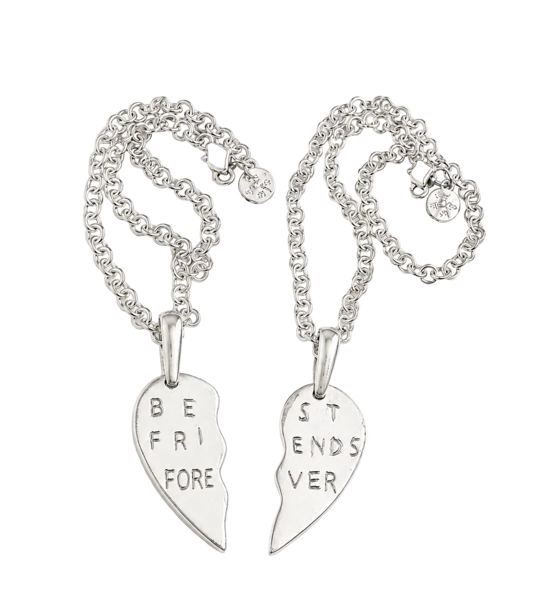 Two silver friendship necklaces with broken heart pendants that read 'BE FRI FORE' and 'ST ENDS VER', displayed on a light cream background with text indicating $575 each.
